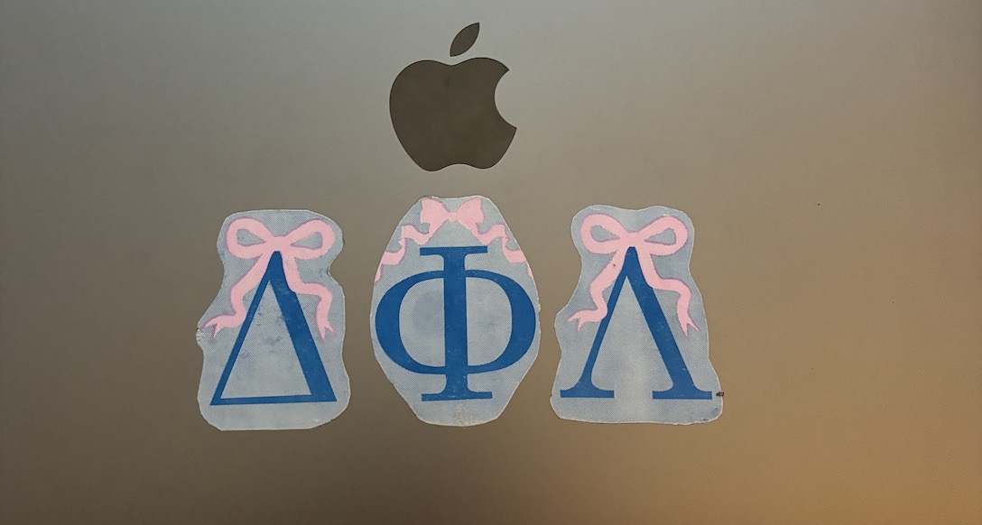 Sorority letter stickers on a computer.